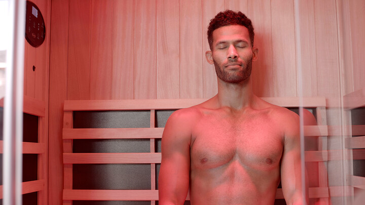 how to use a sauna - man in a sauna with red light