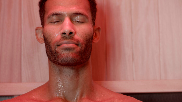 how to use a sauna - closeup of man in sauna with red light