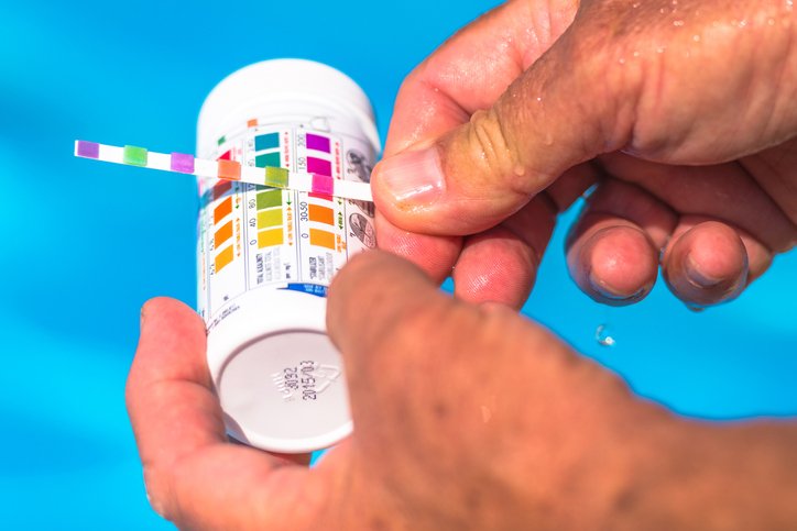 hot tub bubbles - checking the pH levels with a pH test strip