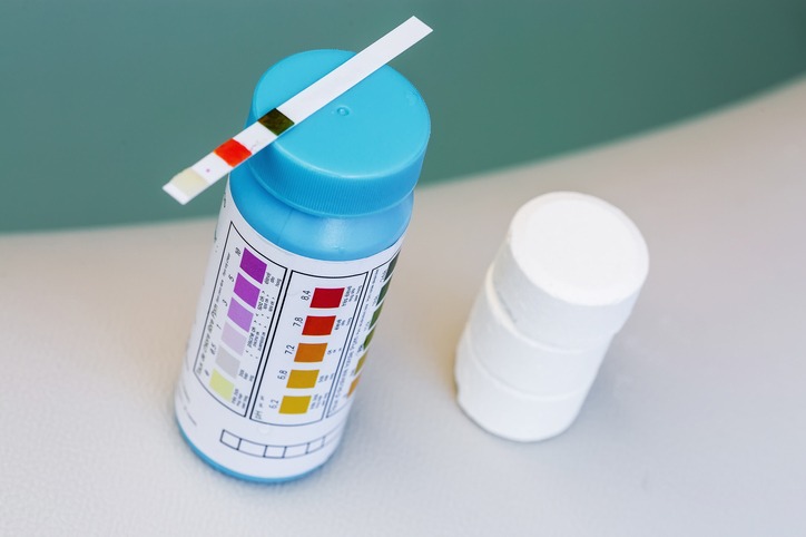 hot tub supplies on edge of spa - ph test strips and chlorine