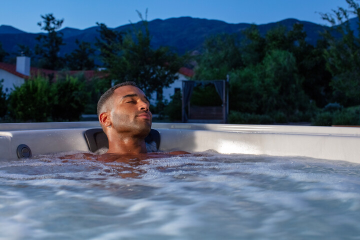 man enjoying hydromassage in hot tub