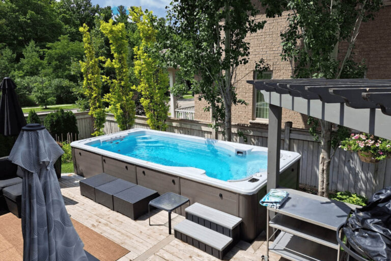 A swim spa installed in a backyard