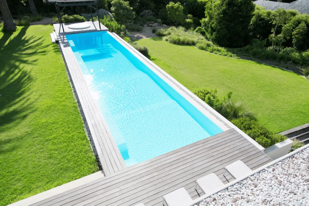 Outdoor, inground lap pool in a yard surrounded by grass