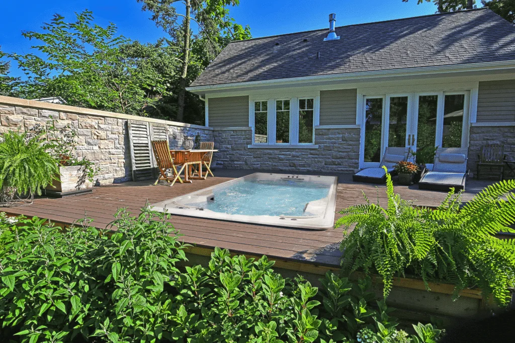 A swim spa installed in ground in a deck