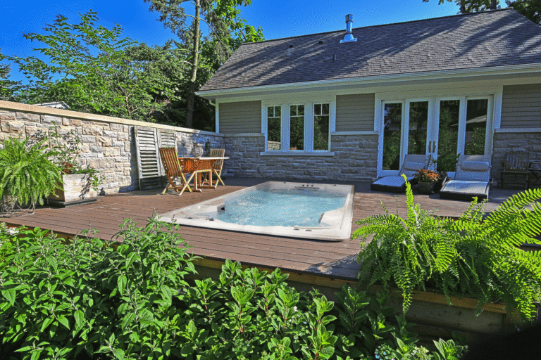 A swim spa installed in ground in a deck