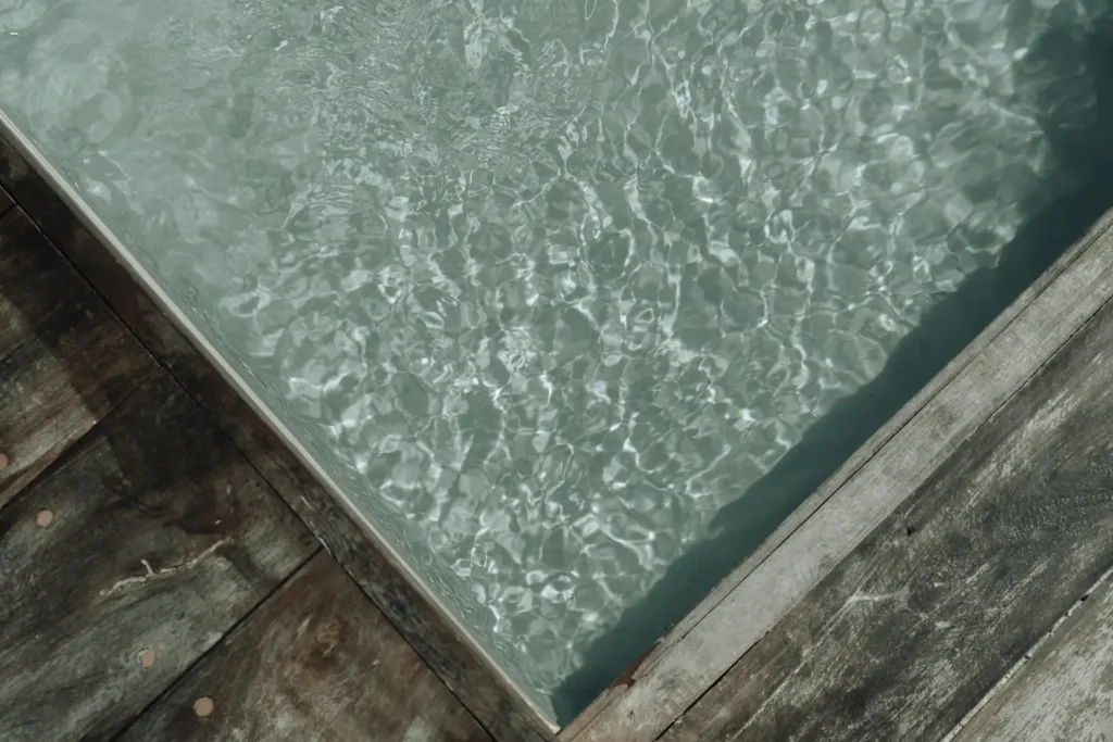the corner of a hot tub on a wooden deck